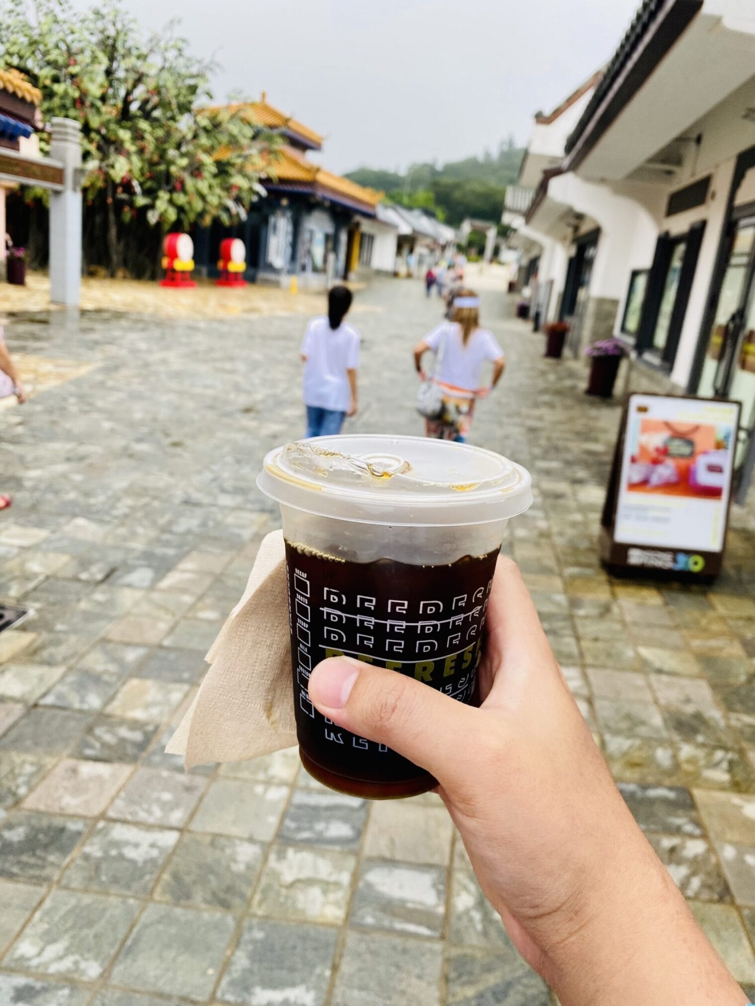 กาแฟเย็นถือตามถนนในหมู่บ้าน Coffee on the street in village