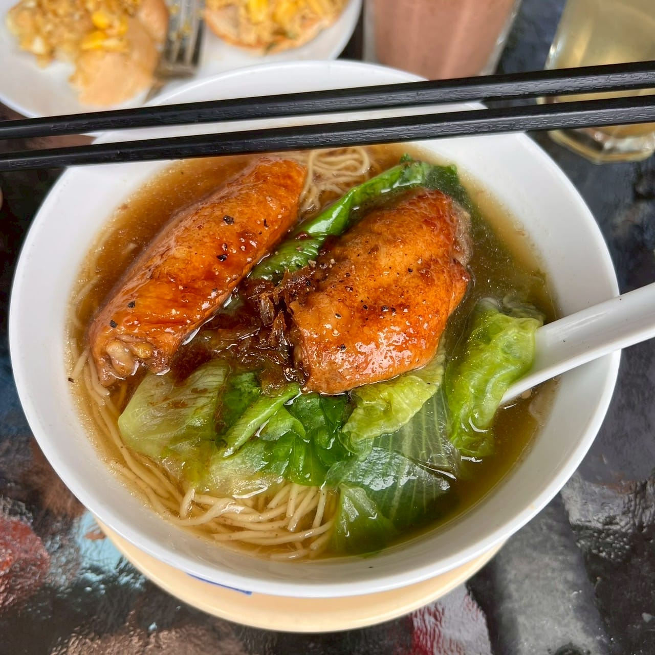 บะหมี่น้ำไก่ทอดและผักกวางตุ้งในชามขาว Fried chicken noodle soup with bok choy in white bowl